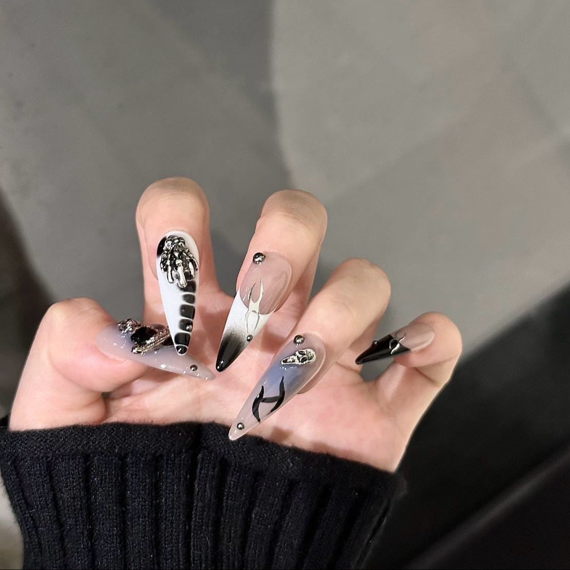 Step into a realm of celestial luxury with the Cosmic Reign Press-On Nails. This bold and edgy set fuses intergalactic aesthetics with dark elegance, featuring chrome accents, planetary embellishments, and gothic-inspired details.