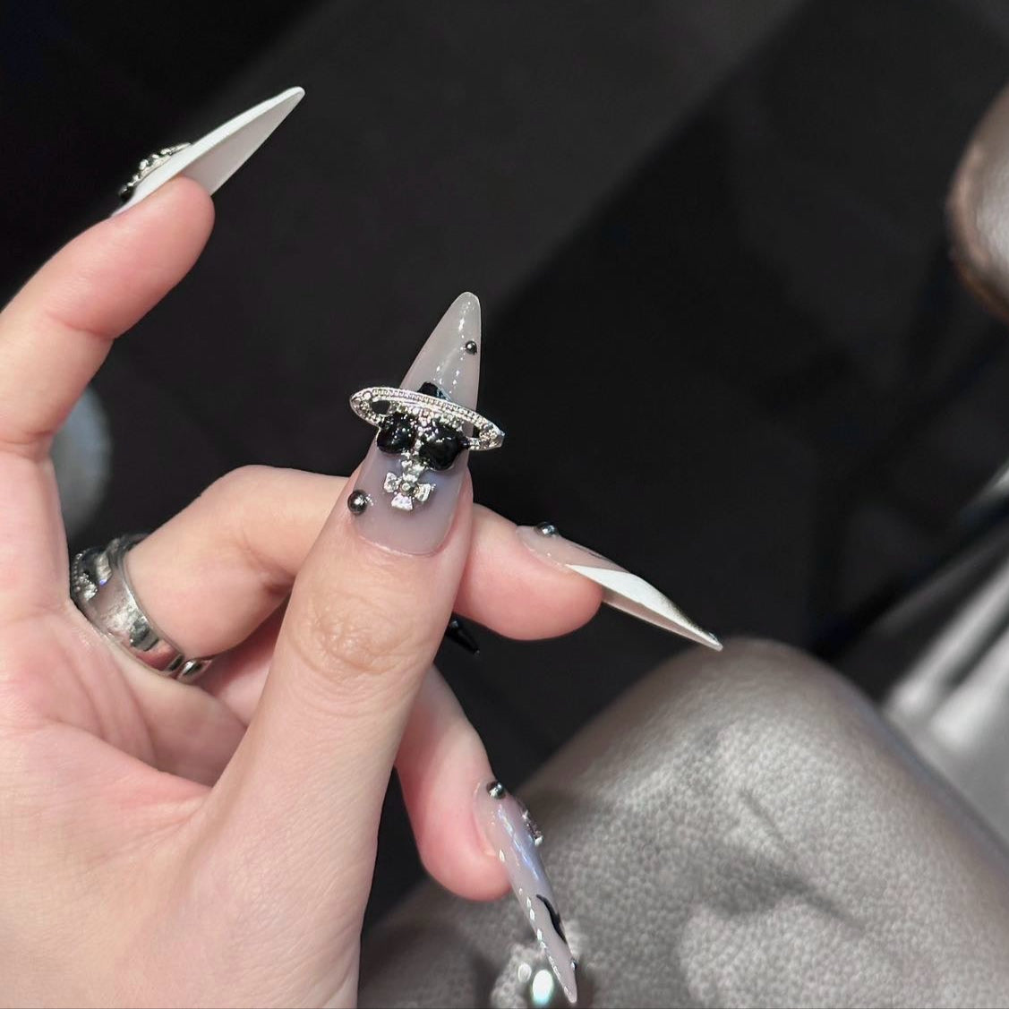 Step into a realm of celestial luxury with the Cosmic Reign Press-On Nails. This bold and edgy set fuses intergalactic aesthetics with dark elegance, featuring chrome accents, planetary embellishments, and gothic-inspired details.