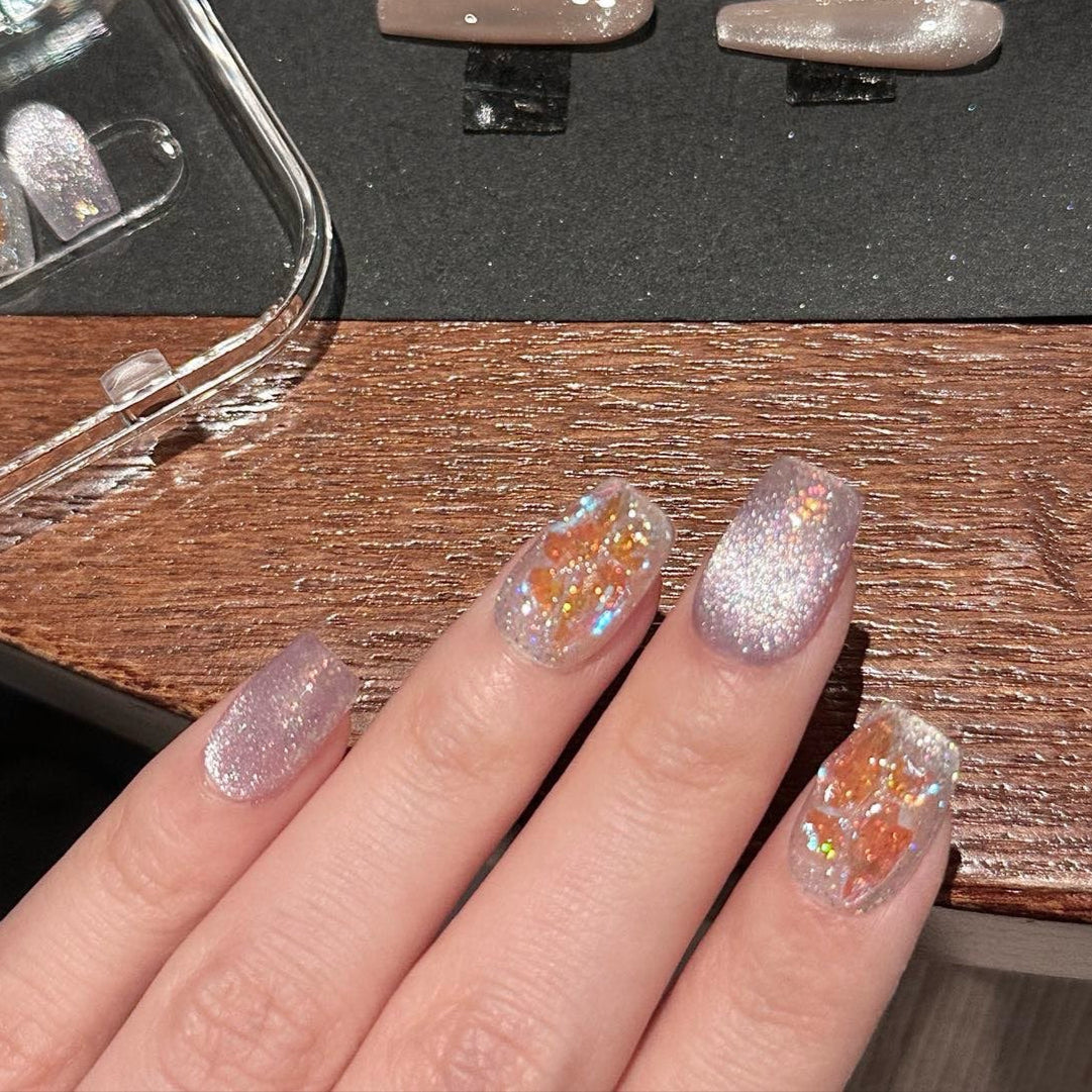 Step into a magical realm with Fairy Dust Press-On Nails, a whimsical blend of shimmering lavender glitter and iridescent gold leaf accents. This enchanting set features a sparkling, ethereal glow that catches the light beautifully, reminiscent of fairy wings and enchanted forests. Paired with a glossy finish and elegant square shape, Fairy Dust brings a touch of fantasy and charm to your style.