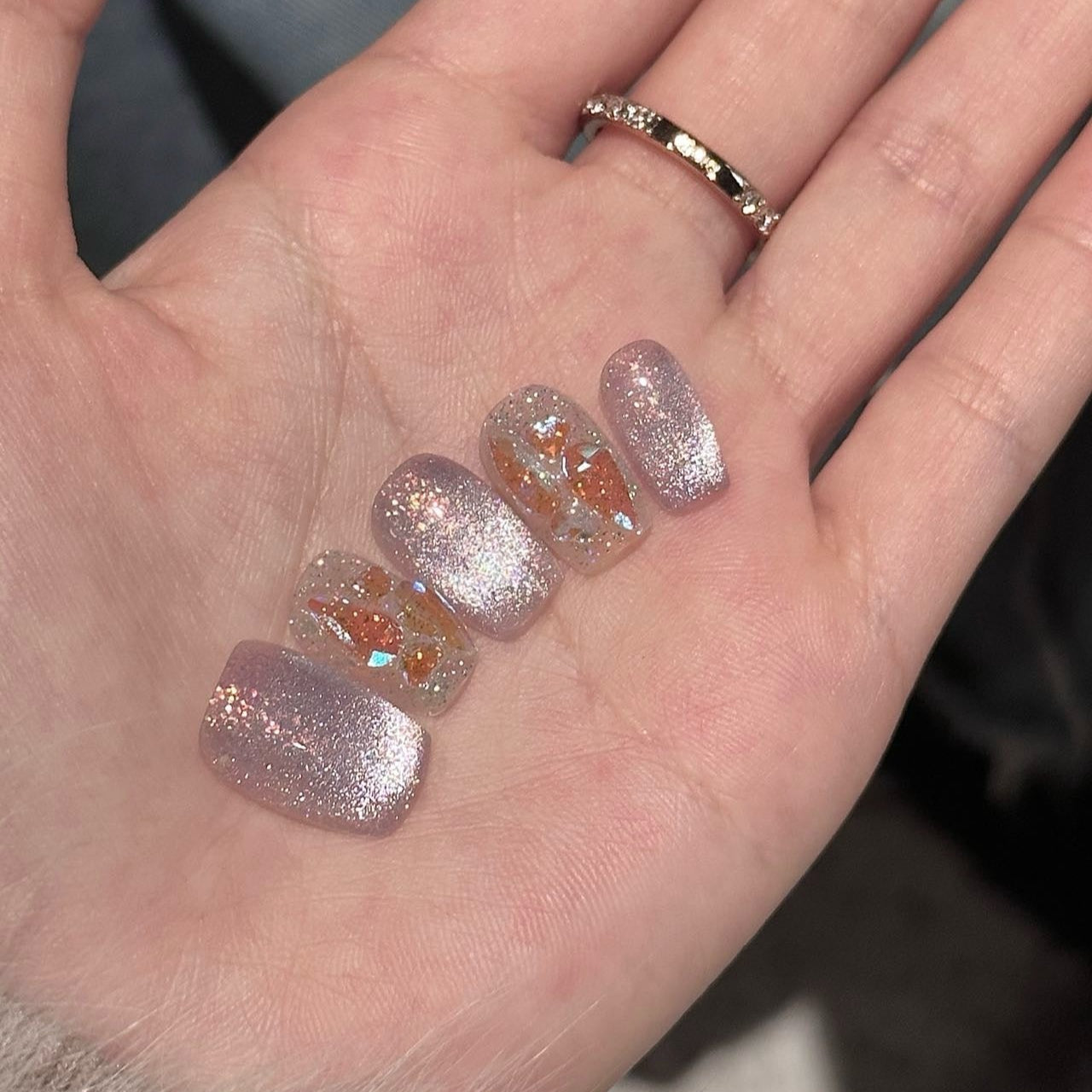 Step into a magical realm with Fairy Dust Press-On Nails, a whimsical blend of shimmering lavender glitter and iridescent gold leaf accents. This enchanting set features a sparkling, ethereal glow that catches the light beautifully, reminiscent of fairy wings and enchanted forests. Paired with a glossy finish and elegant square shape, Fairy Dust brings a touch of fantasy and charm to your style.
