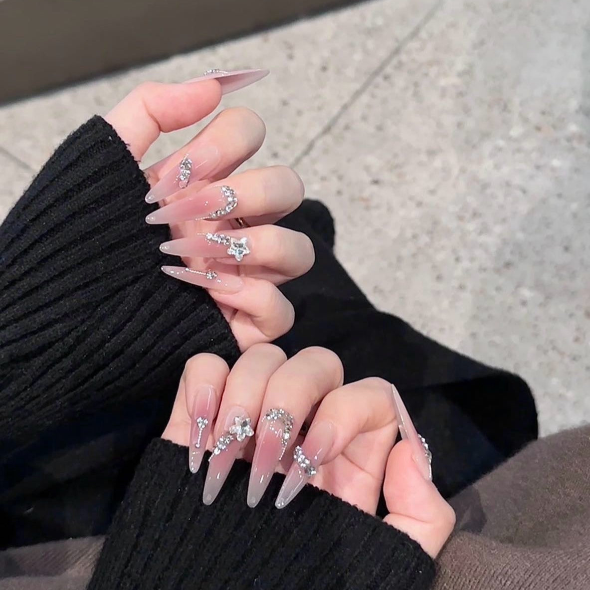 Step into a dreamy realm with Fairy Whisper Press-On Nails. These extra-long stiletto nails feature a delicate pink-to-nude ombre that exudes elegance and charm. Adorned with sparkling diamonds and silver rhinestones, they catch the light beautifully, creating an ethereal, fairy-like glow. Their refreshing and lightweight design adds a touch of magic to every movement.