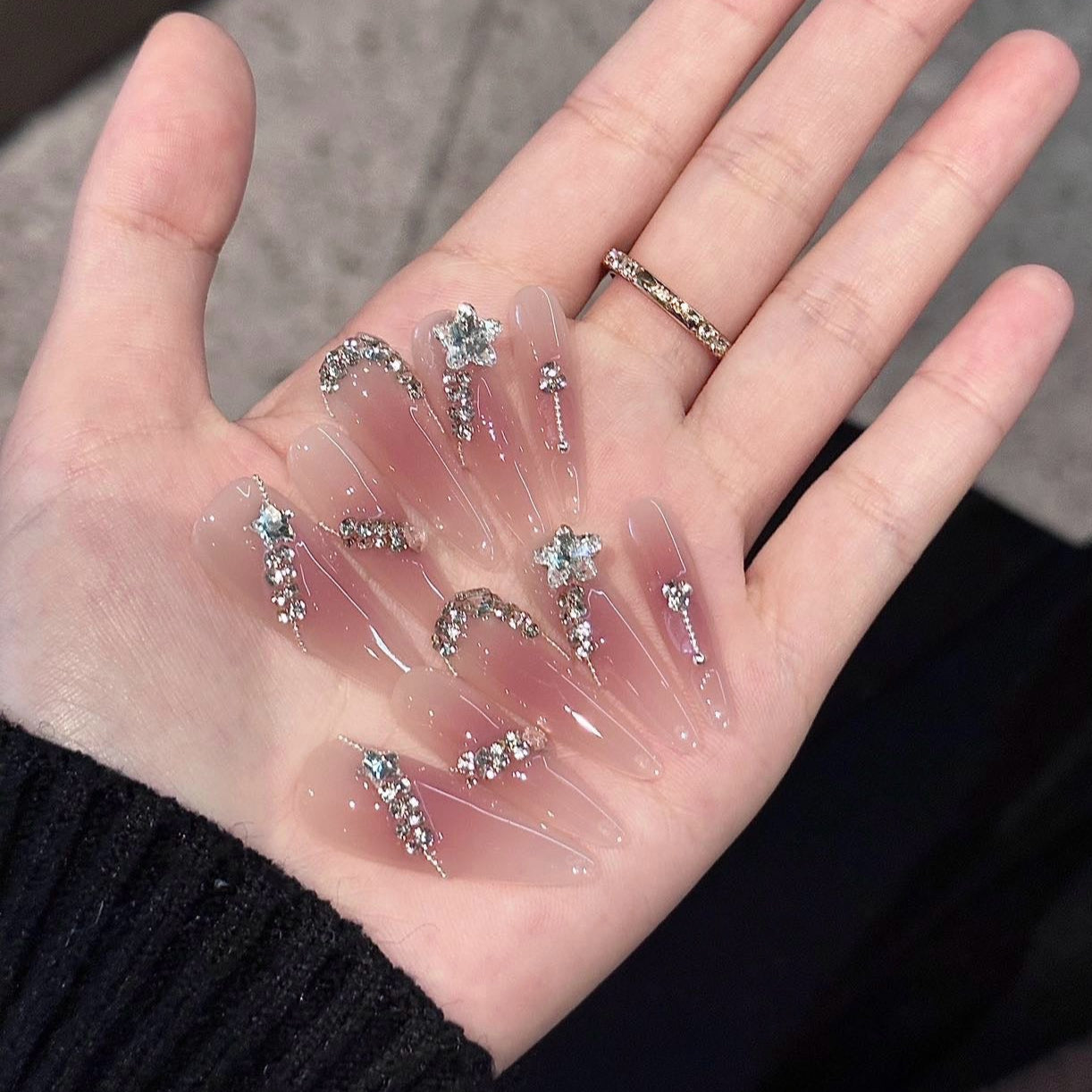 Step into a dreamy realm with Fairy Whisper Press-On Nails. These extra-long stiletto nails feature a delicate pink-to-nude ombre that exudes elegance and charm. Adorned with sparkling diamonds and silver rhinestones, they catch the light beautifully, creating an ethereal, fairy-like glow. Their refreshing and lightweight design adds a touch of magic to every movement.