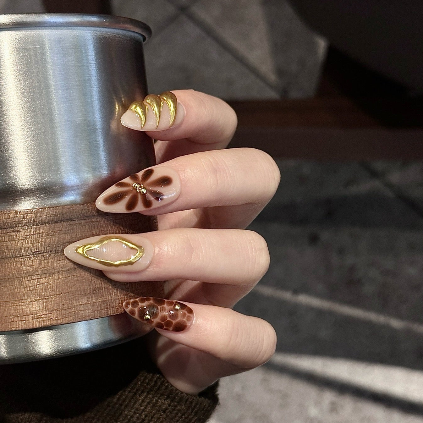 Unleash your wild side with Golden Leopard Press-On Nails, a fierce blend of rich chocolate leopard print, nude-beige base, and luxurious gold accents. This bold set features intricate animal patterns, sculpted gold embellishments, and shimmering star motifs, creating an exotic and glamorous look. The sleek almond shape adds a chic, elongated finish, perfect for those who love a luxurious, fashion-forward aesthetic.