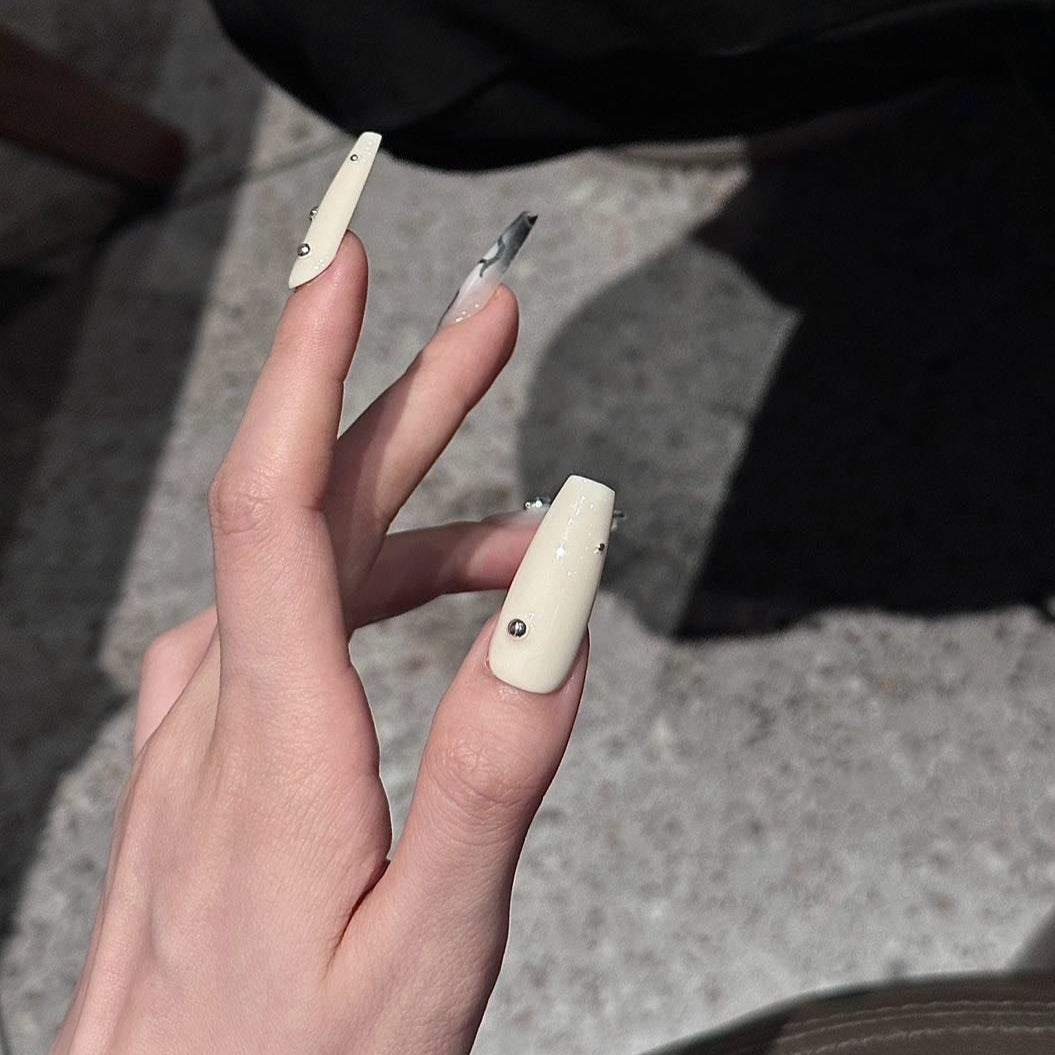 Step into a world of elegance and contrast with the Ivory Eclipse Press-On Nails, a sophisticated blend of creamy ivory and sleek metallic silver. This design combines modern minimalism with bold accents, making it perfect for those who love a refined yet striking aesthetic.