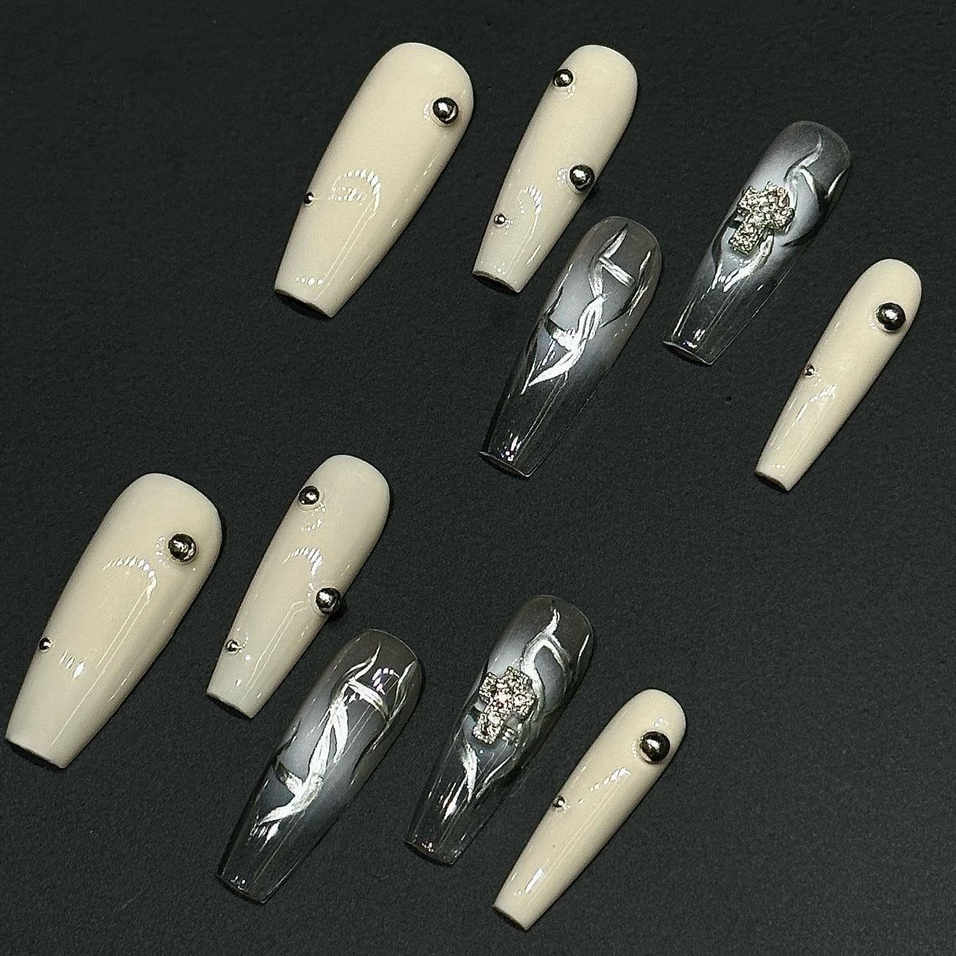 Step into a world of elegance and contrast with the Ivory Eclipse Press-On Nails, a sophisticated blend of creamy ivory and sleek metallic silver. This design combines modern minimalism with bold accents, making it perfect for those who love a refined yet striking aesthetic.