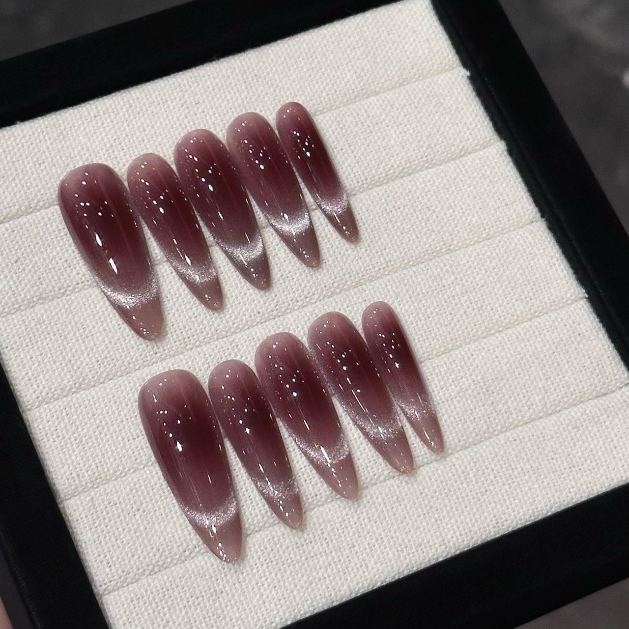 Indulge in understated luxury with Mocha Mystique Press-On Nails. These extra-long stiletto nails feature a rich mocha-toned cat-eye effect, blending seamlessly into a soft ombré for a sultry yet sophisticated look. The magnetic shimmer adds depth and dimension, creating an alluring, velvety finish that catches the light with every movement.