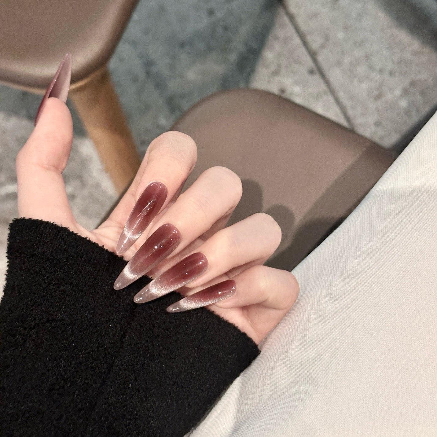 Indulge in understated luxury with Mocha Mystique Press-On Nails. These extra-long stiletto nails feature a rich mocha-toned cat-eye effect, blending seamlessly into a soft ombré for a sultry yet sophisticated look. The magnetic shimmer adds depth and dimension, creating an alluring, velvety finish that catches the light with every movement.