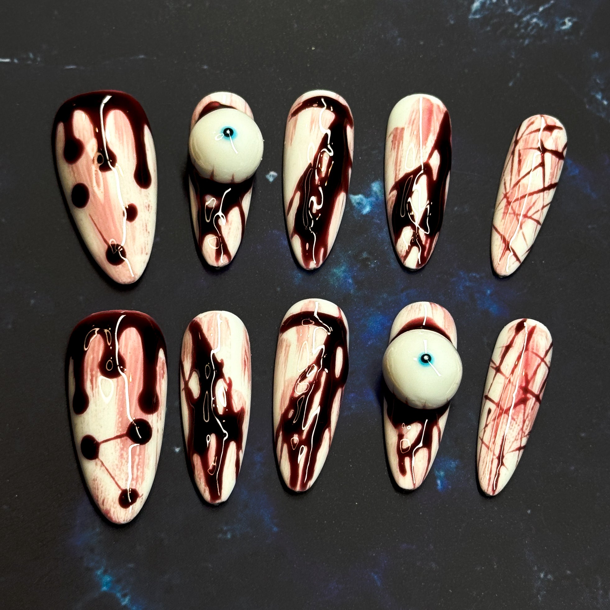 • Horror-Inspired: Realistic blood drip and splatter effects for a chilling vibe.
• 3D Eyeball Accent: A standout piece that adds shock factor and fun.
• Stiletto Shape: Sharp, bold, and dramatic — perfect for a killer manicure.
• Handmade & Reusable: Crafted with high-quality gel for long-lasting wear.
• Halloween Ready: Ideal for costumes, parties, or anyone who loves dark, edgy nails.
