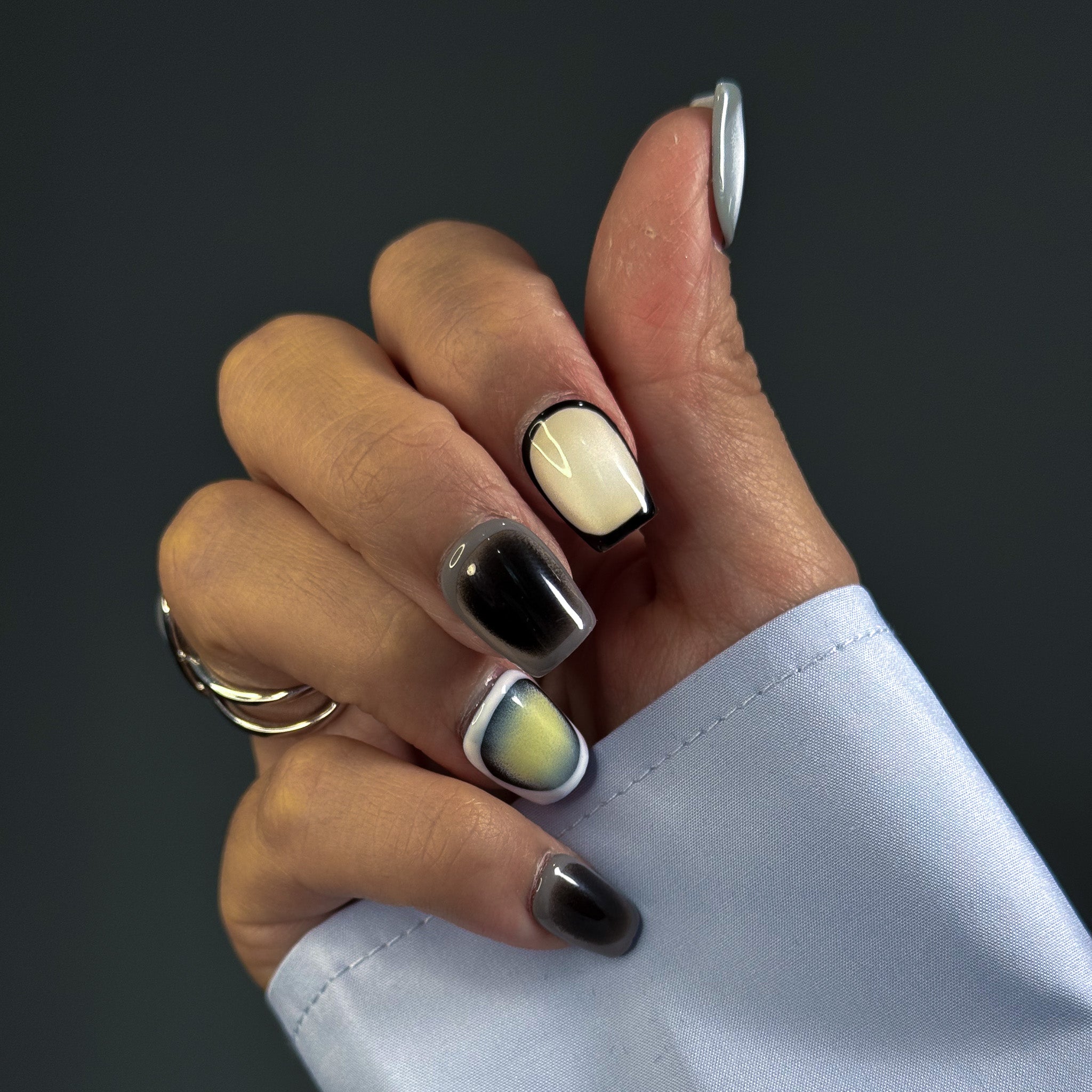 Embrace modern sophistication with Monochrome Mirage Press-On Nails, featuring a short square shape and a minimalist cycle pattern in black, white, and grey. This chic set showcases a subtle cat-eye effect that shifts under different lighting, creating a multidimensional, elegant look. Perfect for those who love a clean, contemporary aesthetic, Monochrome Mirage brings a touch of refined minimalism to your style.