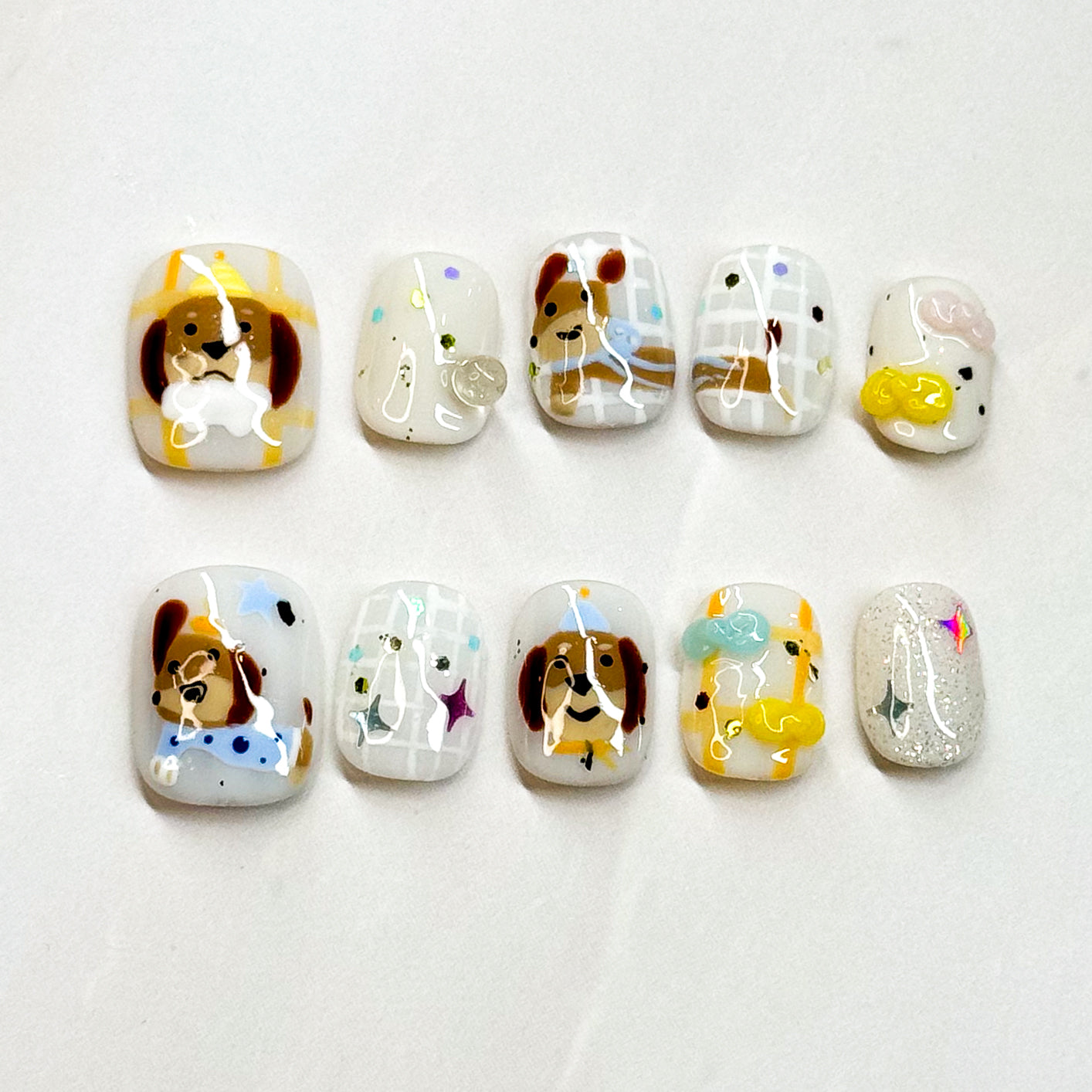 Key Features:
• Puppy Perfect: Hand-painted dog faces with sweet little details.
• Fun Accents: Includes bones, stars, paw prints, and sparkly touches.
• Short Square Shape: Easy to wear and perfect for daily use.
• Playful Colors: Warm browns, soft whites, and pastel pops for a cheerful look.
• Handmade & Reusable: Crafted with premium 3D gel for durability and charm.