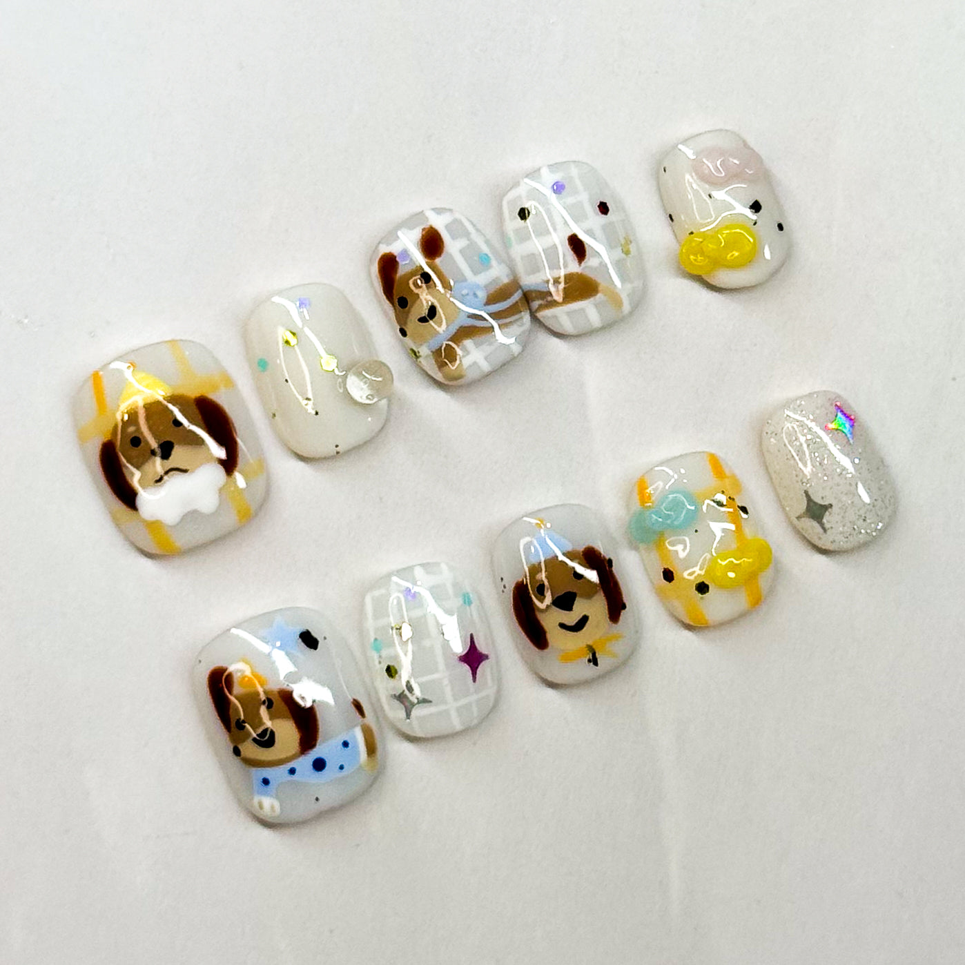 Key Features:
• Puppy Perfect: Hand-painted dog faces with sweet little details.
• Fun Accents: Includes bones, stars, paw prints, and sparkly touches.
• Short Square Shape: Easy to wear and perfect for daily use.
• Playful Colors: Warm browns, soft whites, and pastel pops for a cheerful look.
• Handmade & Reusable: Crafted with premium 3D gel for durability and charm.