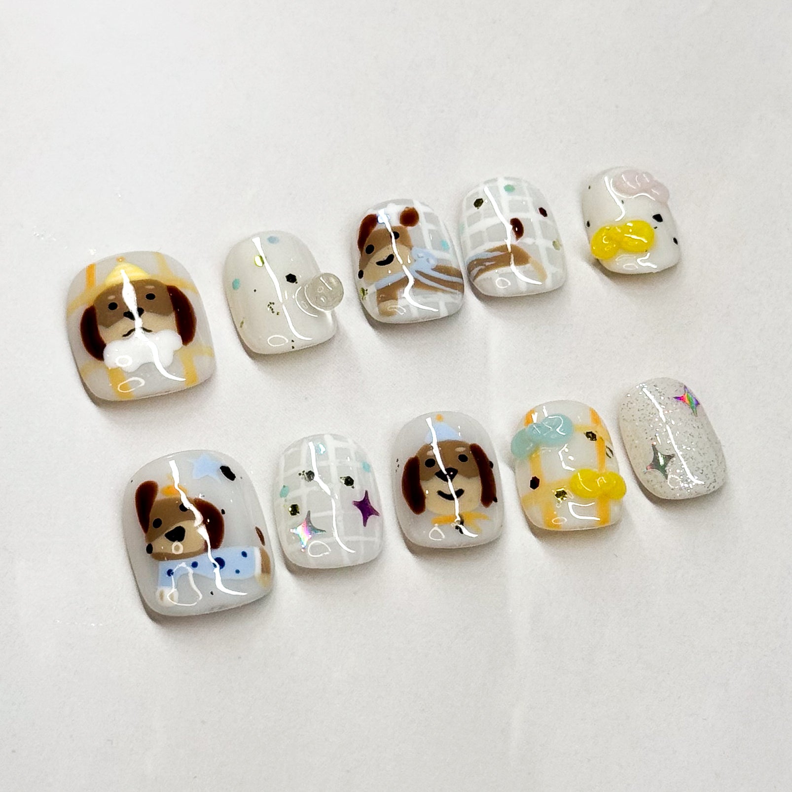 Key Features:
• Puppy Perfect: Hand-painted dog faces with sweet little details.
• Fun Accents: Includes bones, stars, paw prints, and sparkly touches.
• Short Square Shape: Easy to wear and perfect for daily use.
• Playful Colors: Warm browns, soft whites, and pastel pops for a cheerful look.
• Handmade & Reusable: Crafted with premium 3D gel for durability and charm.