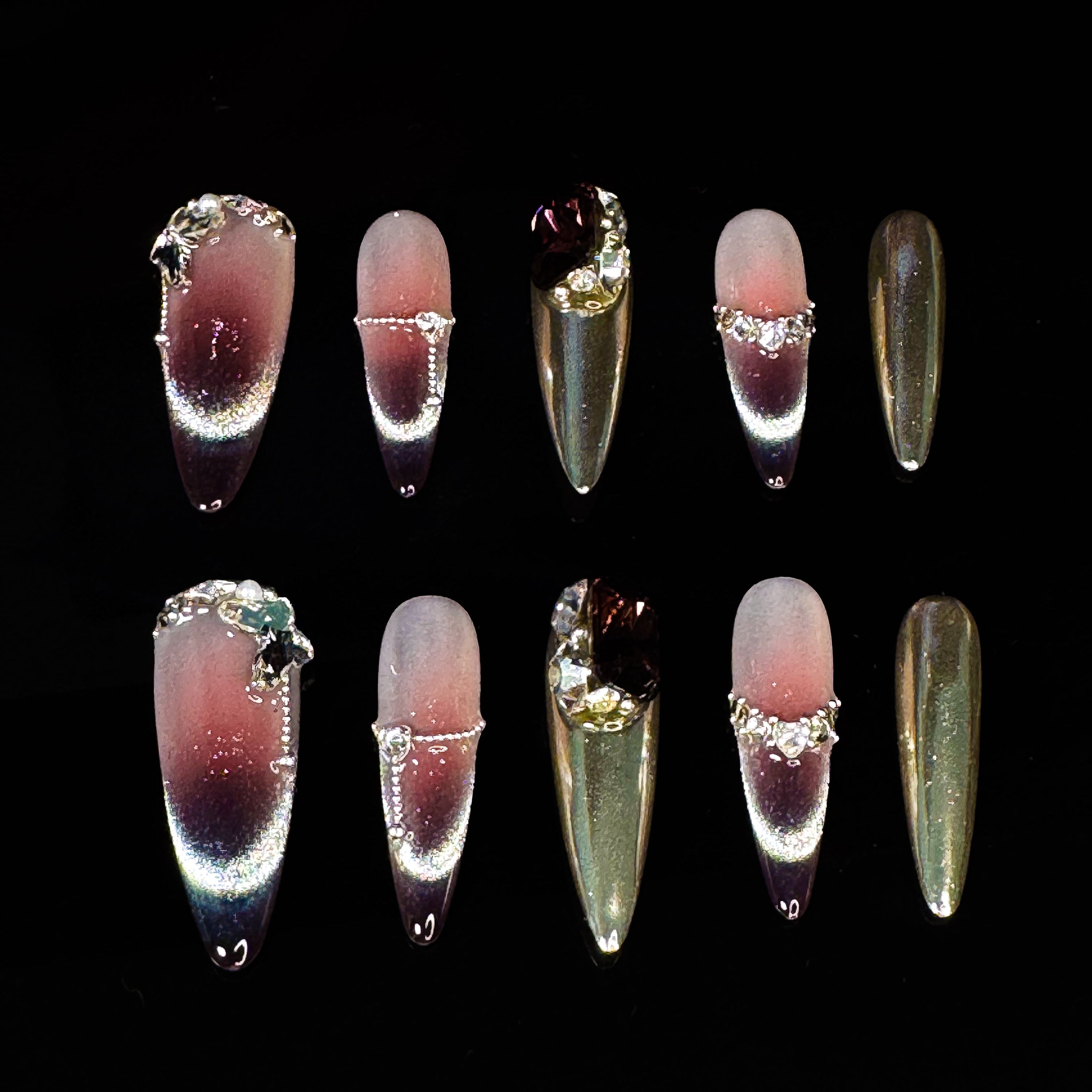 Indulge in pure luxury with Royal Mirage Press-On Nails. These extra-long stiletto nails feature a breathtaking purple ombre blended with silver, creating a regal and enchanting look. Accented with dazzling diamonds and gemstone decorations, each nail sparkles with elegance. A mirror-like full silver nail adds a bold, high-fashion edge, while the cat-eye effect enhances the depth and mystery of the design.