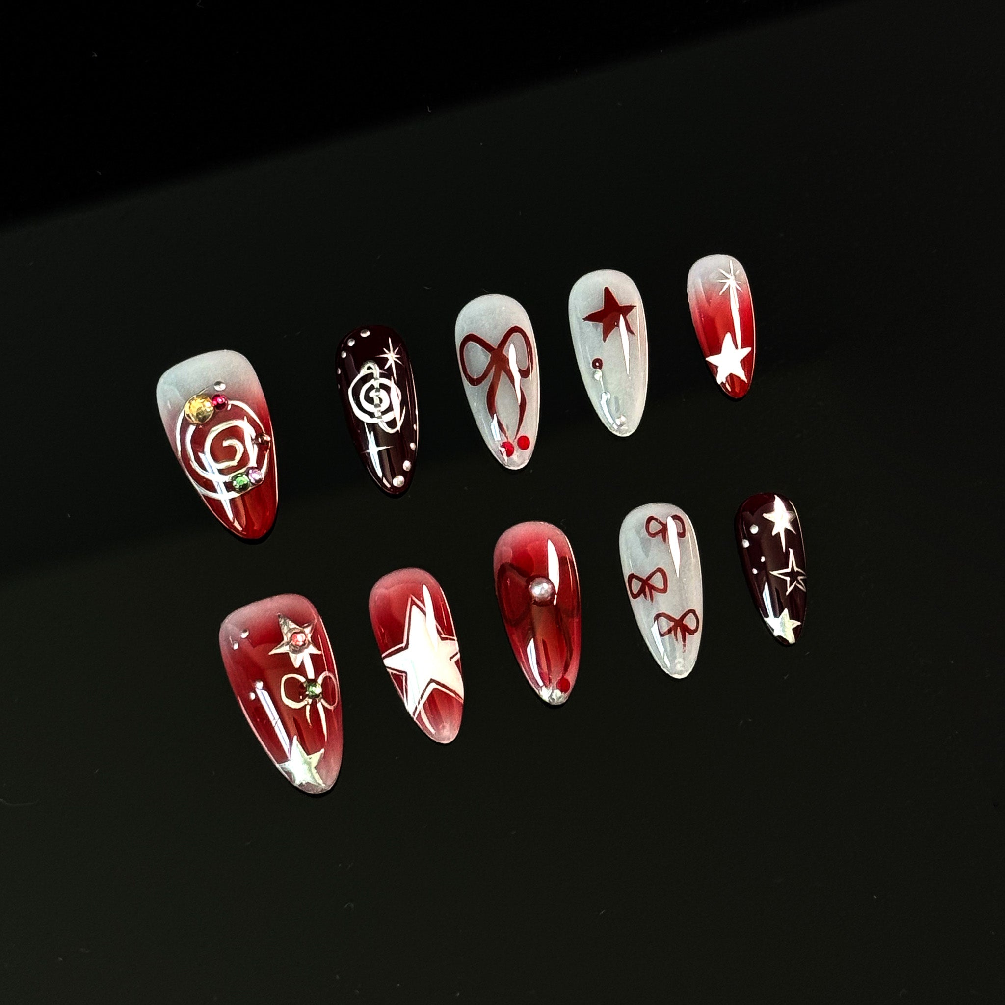 Starlit Celebration Press-On Nails are the perfect festive accessory for those who love to sparkle and shine! Designed with a mix of rich red and deep burgundy hues, these nails are adorned with glittering stars, playful bows, and swirling festive patterns. The gradient ombre effect adds a touch of elegance, making them ideal for holiday parties, special events, or whenever you feel like adding a dash of magic to your look.