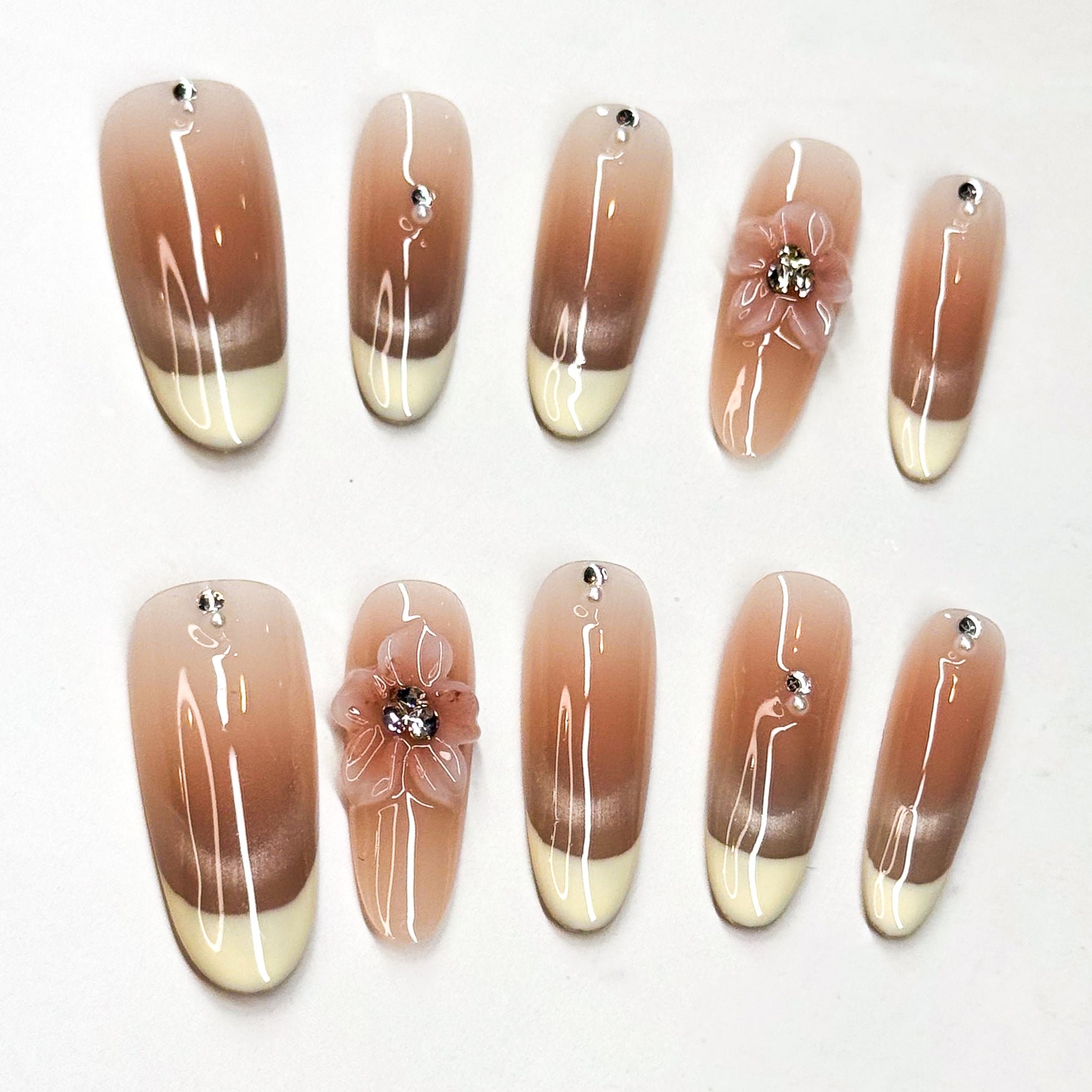 • Ombré Perfection: Smooth transition from warm nude to ivory tips.
• Crystal Glow: Subtle rhinestone accents for a touch of sparkle.
• 3D Floral Accent: Handcrafted flower detail for romantic charm.
• Long Shape: Sleek silhouette that elongates fingers.
• Handmade & Reusable: Salon-quality, durable, and customizable.
