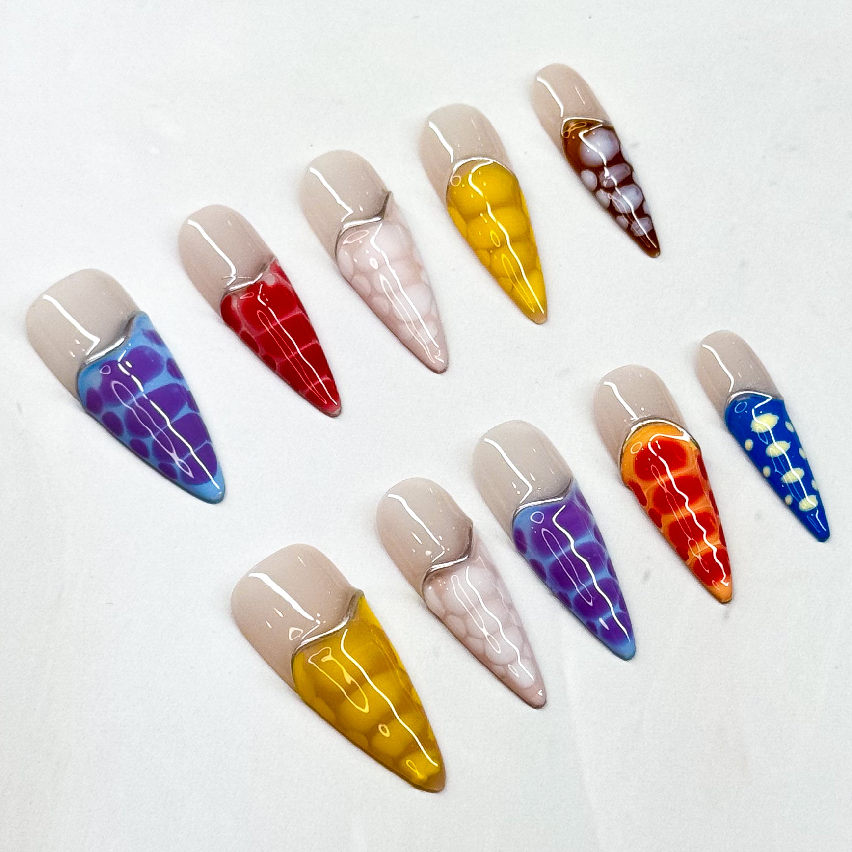 • Color Splash: Vibrant mix of purple, red, yellow, orange, blue, and more.

• Abstract Design: Translucent reptile-scale effect for a modern edge.

• Nude Contrast: Soft neutral base keeps the bold tones wearable.

• Long Stiletto/ Medium Almond Shape: Striking silhouette perfect for statement looks.

• Handmade &amp; Reusable: High-quality finish, built to last.