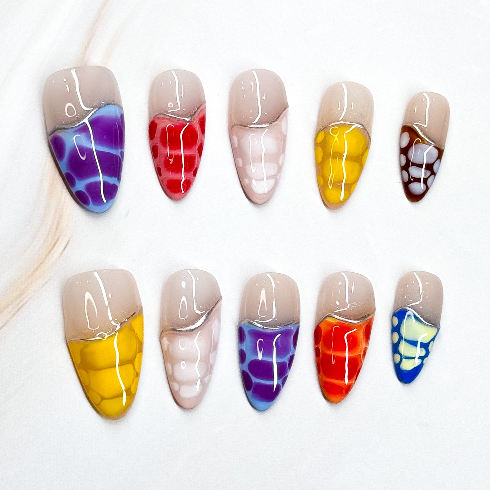 • Color Splash: Vibrant mix of purple, red, yellow, orange, blue, and more.

• Abstract Design: Translucent reptile-scale effect for a modern edge.

• Nude Contrast: Soft neutral base keeps the bold tones wearable.

• Long Stiletto/ Medium Almond Shape: Striking silhouette perfect for statement looks.

• Handmade &amp; Reusable: High-quality finish, built to last.
