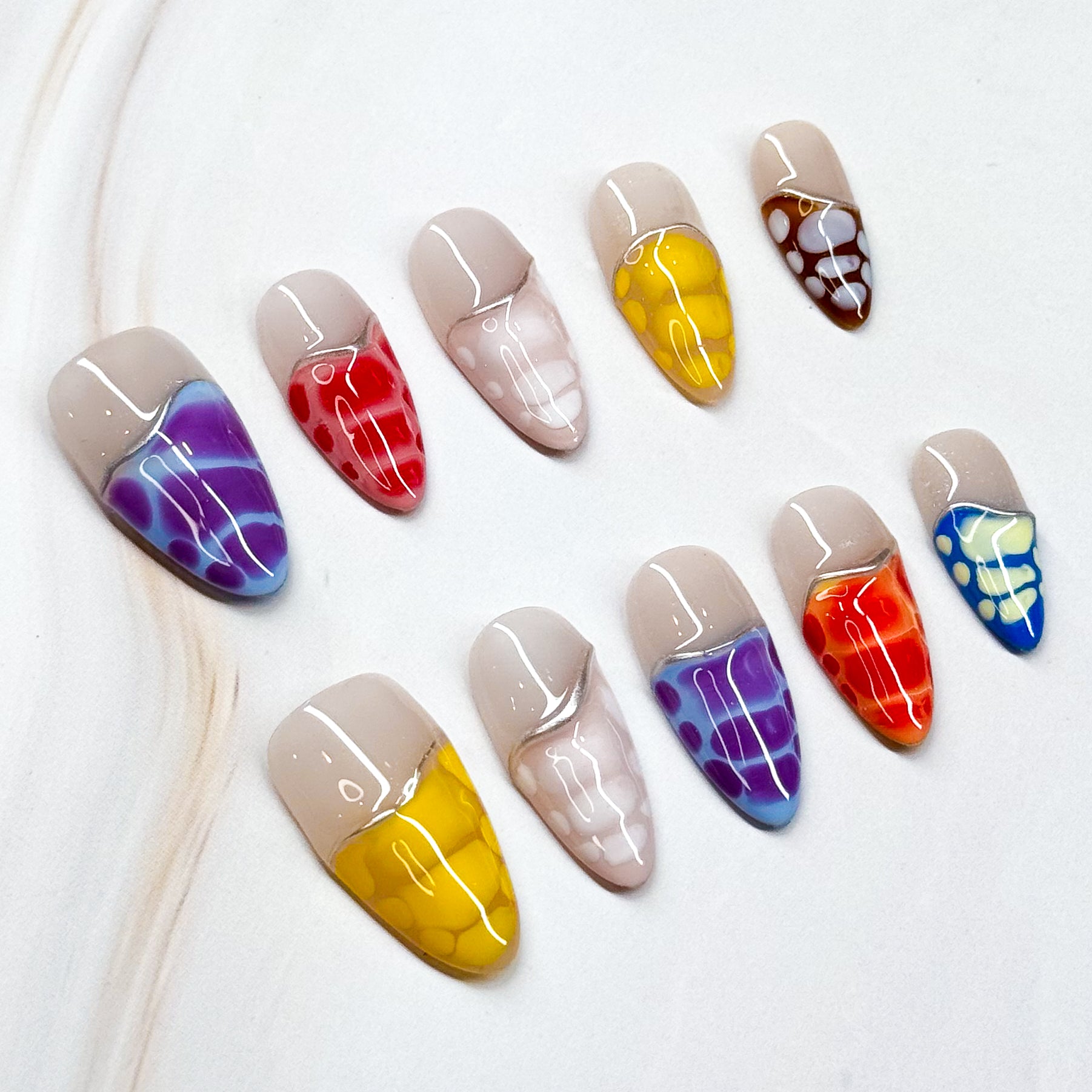 • Color Splash: Vibrant mix of purple, red, yellow, orange, blue, and more.

• Abstract Design: Translucent reptile-scale effect for a modern edge.

• Nude Contrast: Soft neutral base keeps the bold tones wearable.

• Long Stiletto/ Medium Almond Shape: Striking silhouette perfect for statement looks.

• Handmade &amp; Reusable: High-quality finish, built to last.