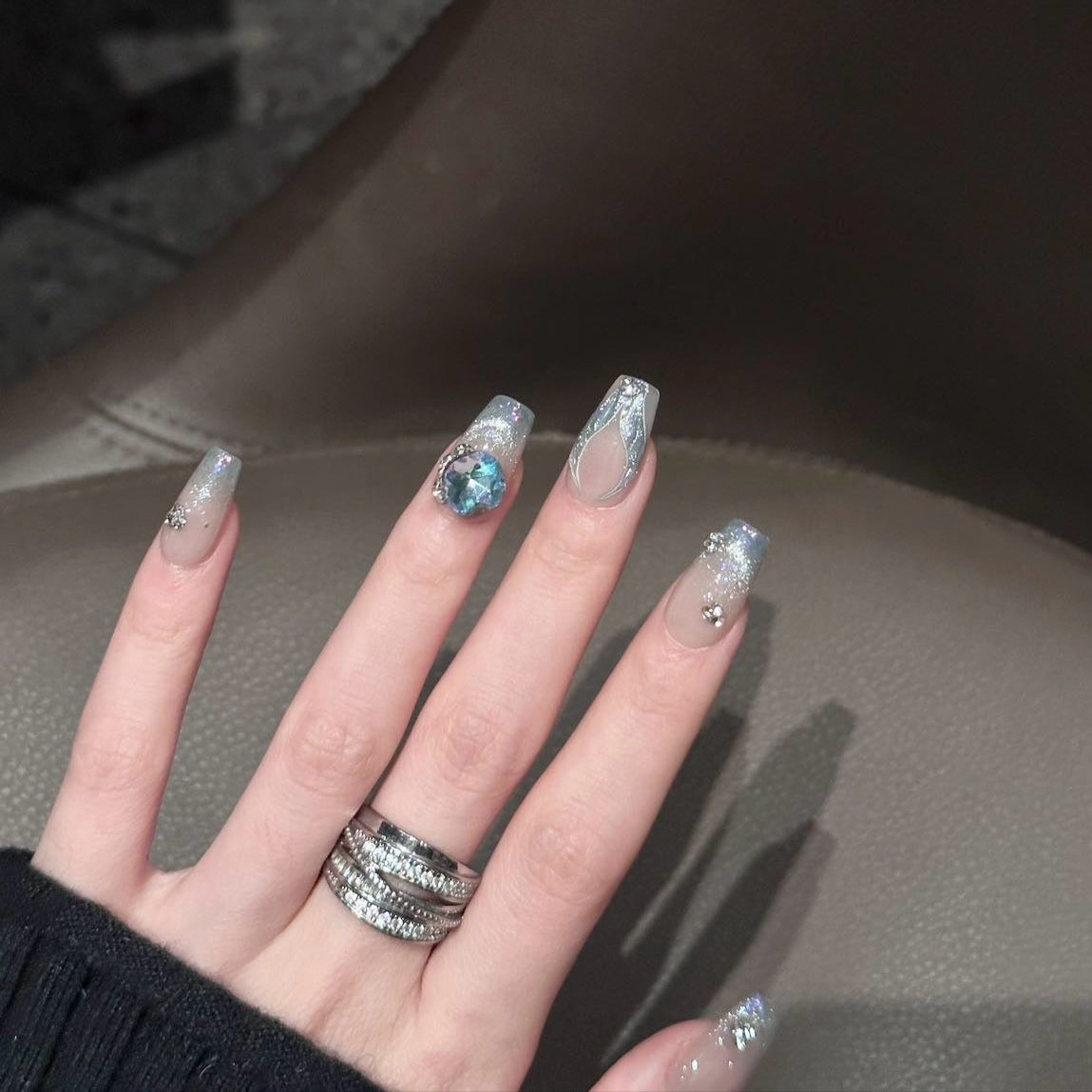 Embrace timeless elegance with the Opulent Aura Press-On Nails, a stunning blend of shimmering champagne hues and opalescent accents. Designed in a short coffin shape for sophisticated simplicity, this set features glittering cat-eye effects and intricate jewel embellishments, capturing the essence of refined luxury. The subtle nude base is beautifully enhanced with iridescent overlays and crystal accents, giving your nails a radiant, luminous glow.