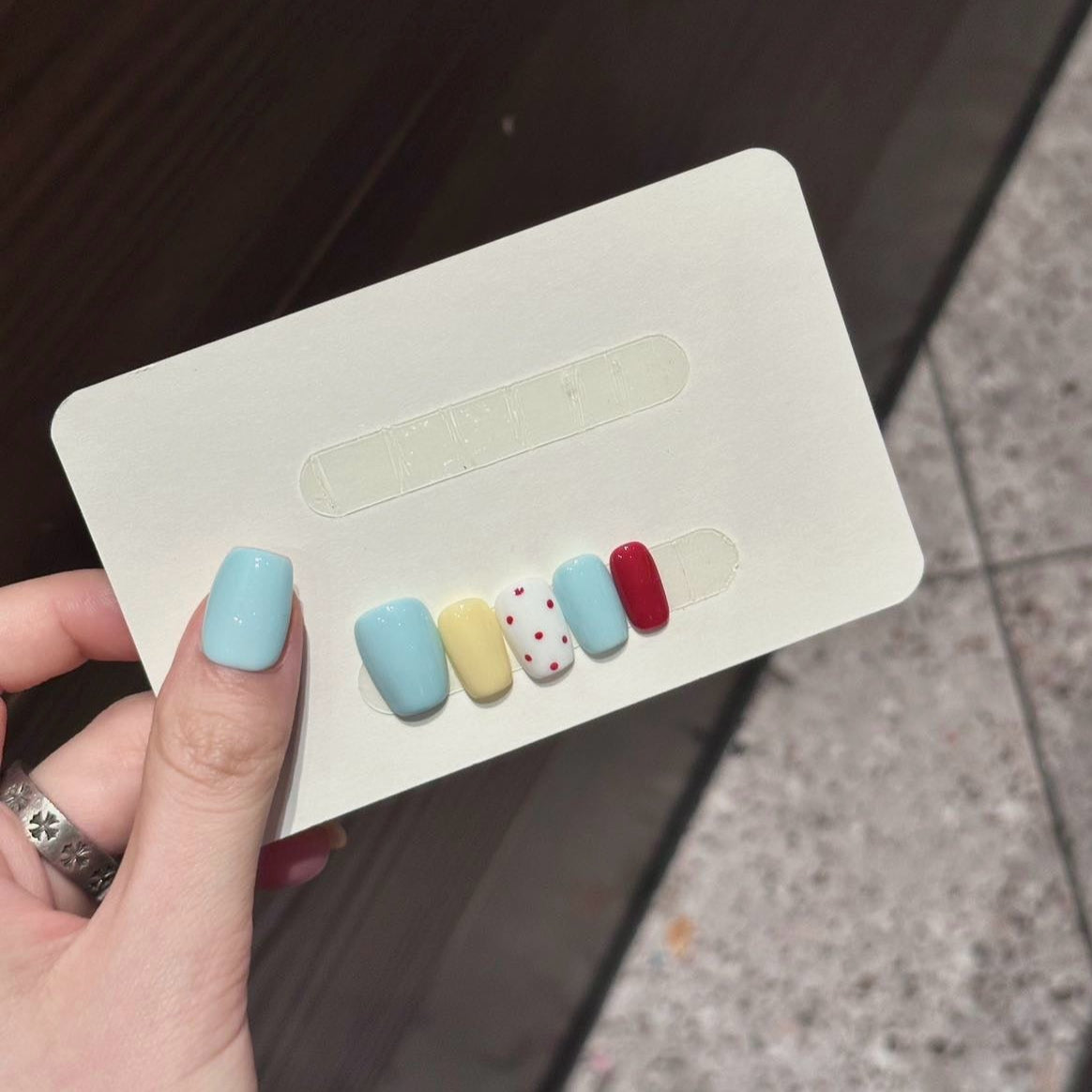 Add a playful touch to your style with Polka Dot Pop Press-On Nails, a vibrant mix of pastel blue, lemon yellow, cherry red, and playful red polka dots on white. This fun and whimsical set features a glossy finish and a cheerful color palette that exudes youthful energy and charm. With a structured short square shape, Polka Dot Pop brings a burst of retro-inspired fun to your fingertips.