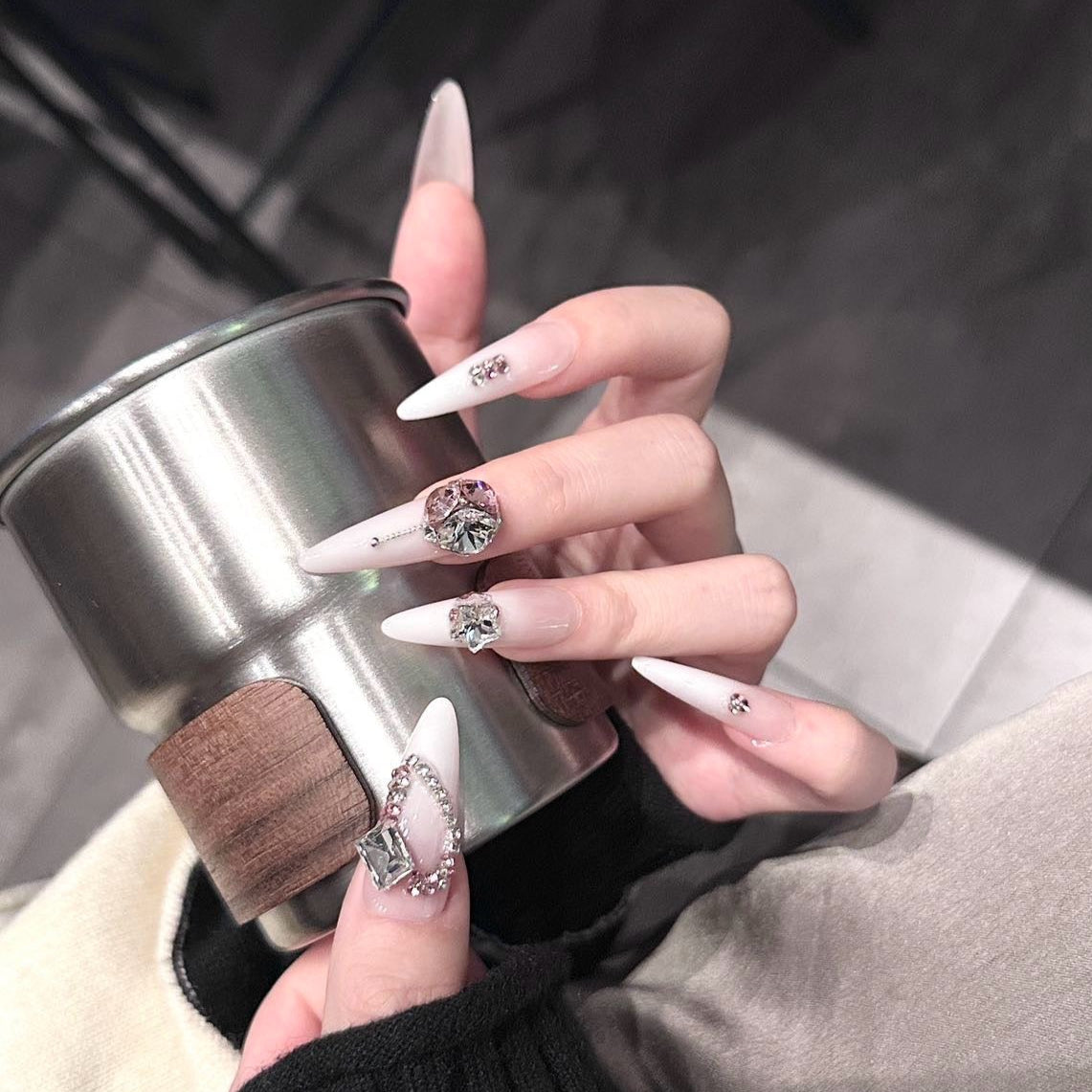 Step into opulence and grace with the Rose Empress Press-On Nails, a regal and exquisitely designed set that embodies luxury and sophistication. This romantic yet bold design features a soft pink-to-white ombré base adorned with crystal embellishments, rose-gold accents, and dazzling gemstone clusters.