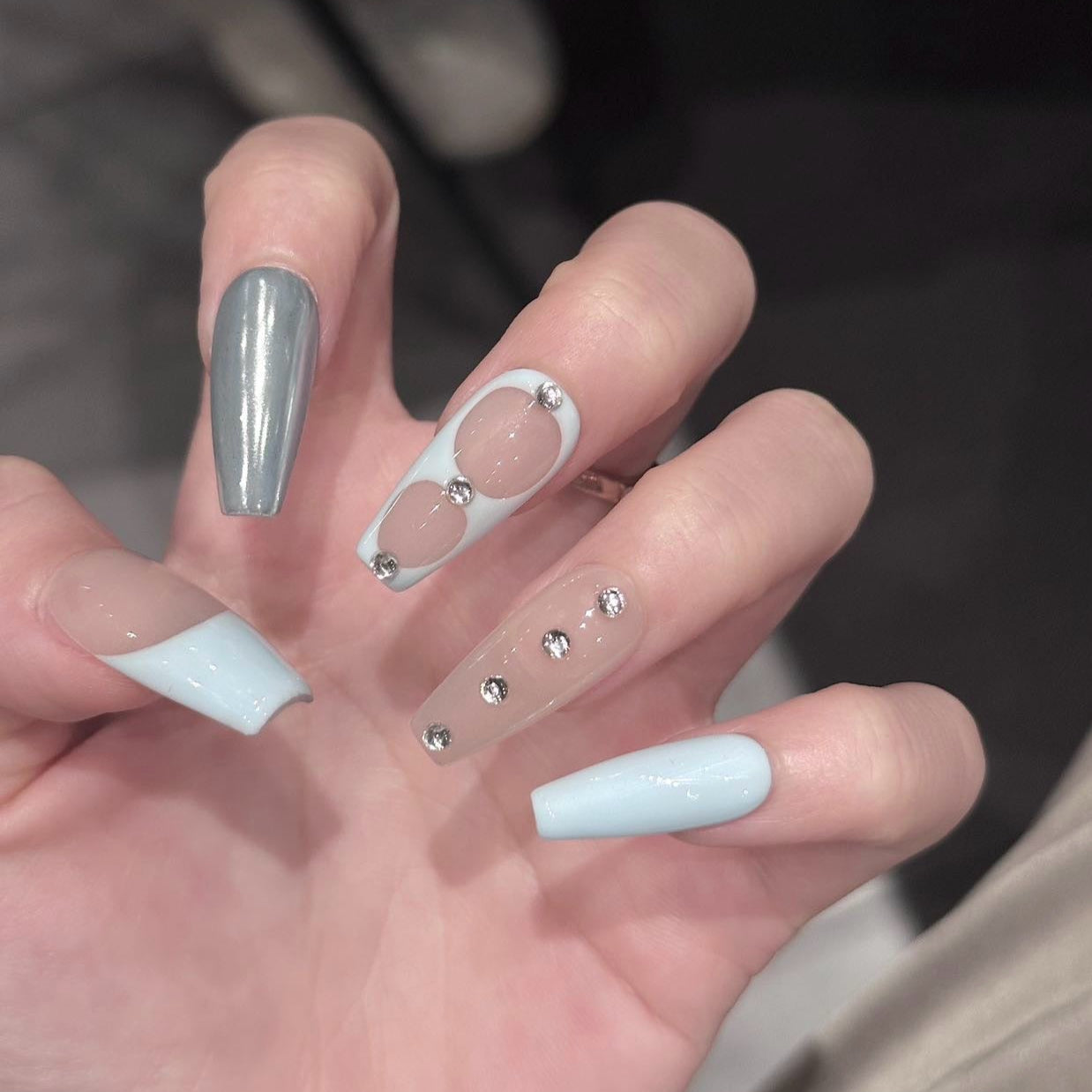 Serene Luxe Press-On Nails embody a perfect blend of minimalist sophistication and modern elegance. Featuring soft nude, baby blue, crisp white, and metallic silver accents, this set offers a dreamy, polished look for any occasion.